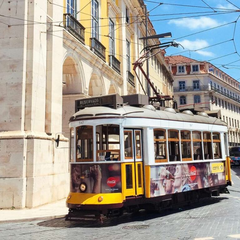Tram running by Praça do Comércio in Lisbon