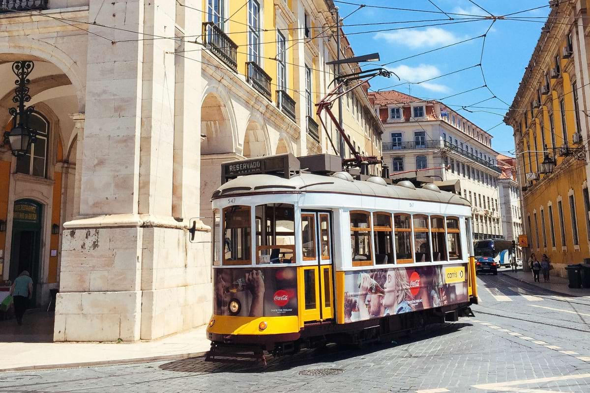 Tram running by Praça do Comércio in Lisbon